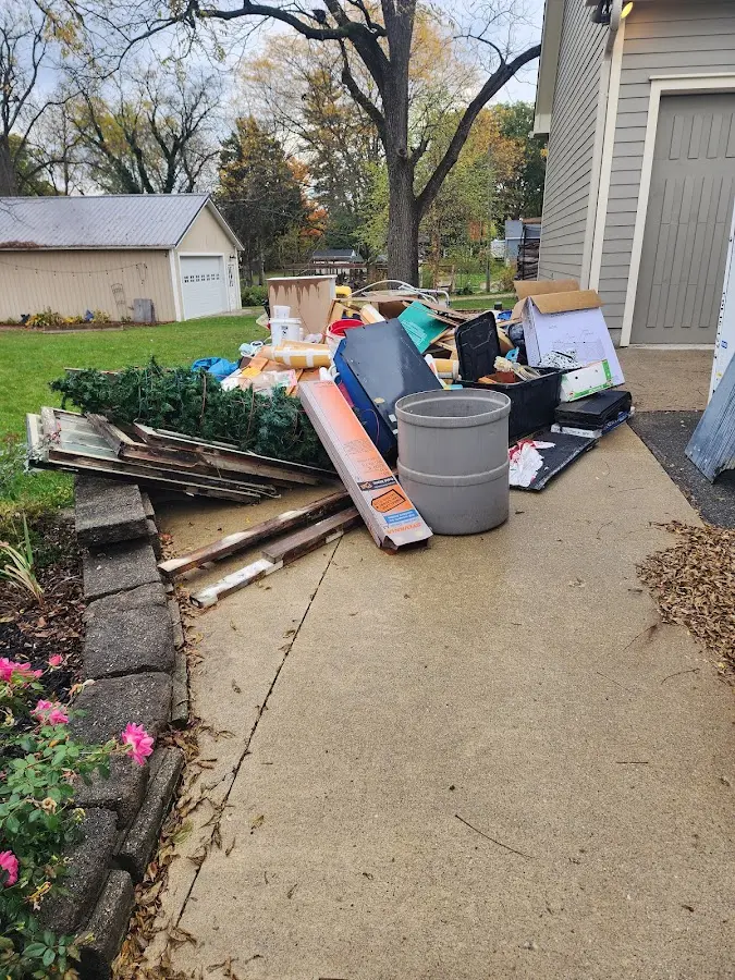 Dumpster being loaded with debris for Estate Cleanout Dumpster Rental in Hunters Creek Village